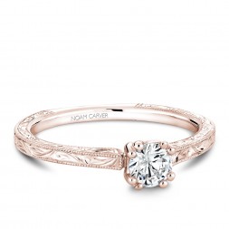 A Carver Studio engraved rose gold engagement ring with a round center stone.