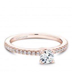 A solitaire Carver Studio rose gold engagement ring with 23 diamonds.