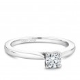 A solitaire Carver Studio white gold engagement ring with a round center stone.