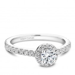 A halo Carver Studio white gold engagement ring with a round center stone.