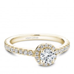 A halo Carver Studio yellow gold engagement ring with a round center stone.