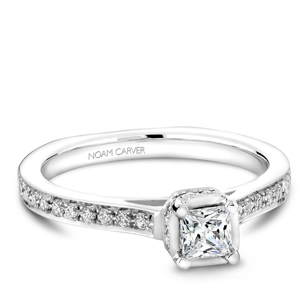 A solitaire Carver Studio white gold engagement ring with a princess diamond and 35 diamonds.