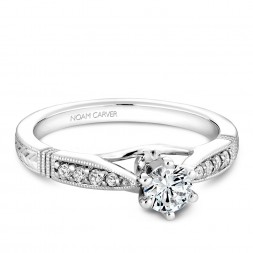A vintage Carver Studio white gold engagement ring with 9 diamonds.
