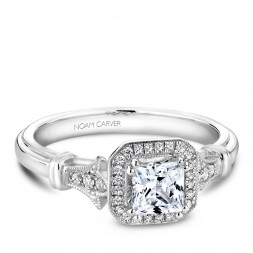 A vintage Carver Studio white gold engagement ring with a princess center stone and 23 diamonds.