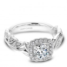 A floral Carver Studio white gold engagement ring with a round center stone and 25 diamonds.