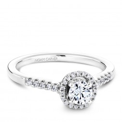 A Carver Studio white gold engagement ring with an oval halo and 44 diamonds.