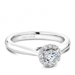 A floral Carver Studio white gold engagement ring with a halo and 13 diamonds.
