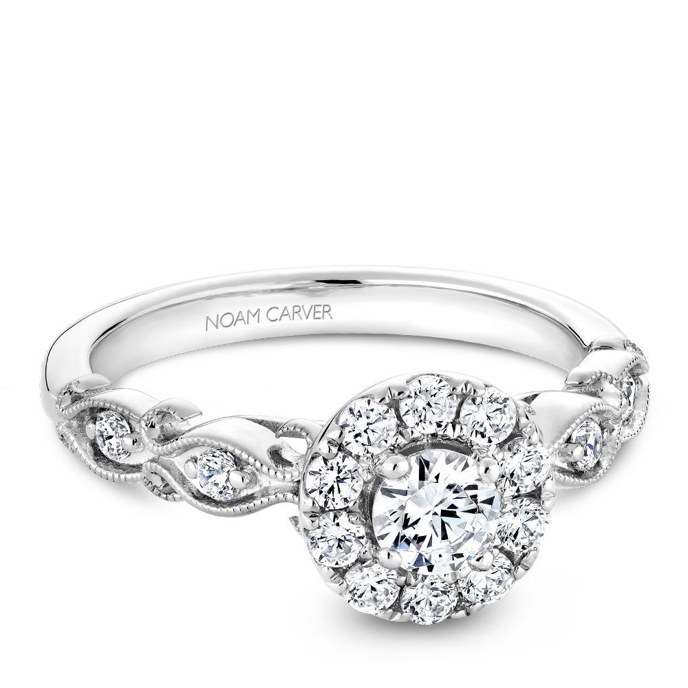 A floral Carver Studio white gold engagement ring with a halo and 17 diamonds.