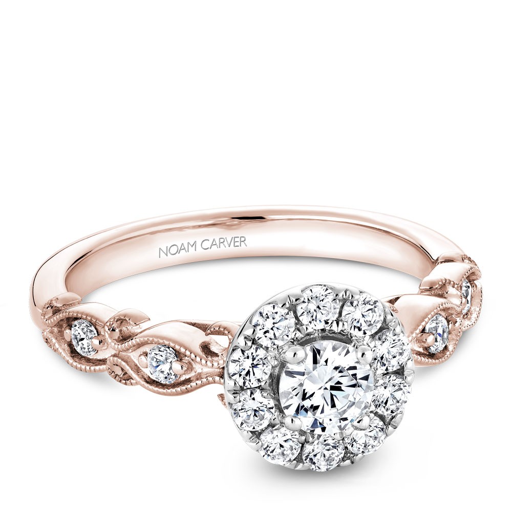 A floral Carver Studio white and rose gold engagement ring with a halo and 17 diamonds.