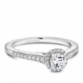 A vintage Carver Studio white gold engagement ring with a halo and 33 diamonds.