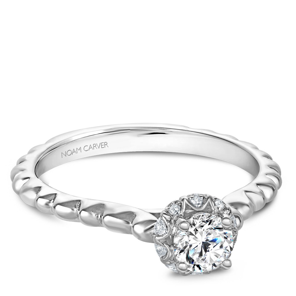 A floral Carver Studio white gold engagement ring with 21 diamonds.