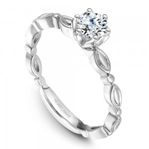 A vintage Carver Studio white gold engagement ring with a round center stone.