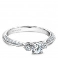 A floral 3-stone Carver Studio white gold engagement ring with 39 diamonds.