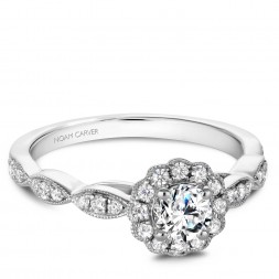 A floral Carver Studio white gold engagement ring with a halo and 31 diamonds.