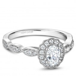 A floral Carver Studio white gold engagement ring with an oval halo and 31 diamonds.