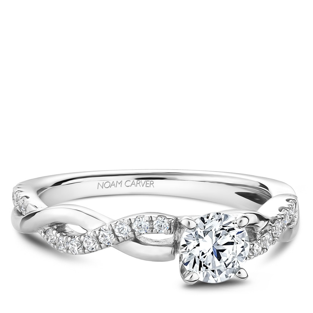 A Carver Studio white gold engagement ring with a twist band and 25 diamonds.