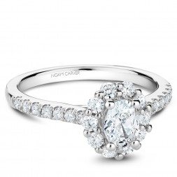 A floral Carver Studio white gold engagement ring with an oval halo and 23 diamonds.